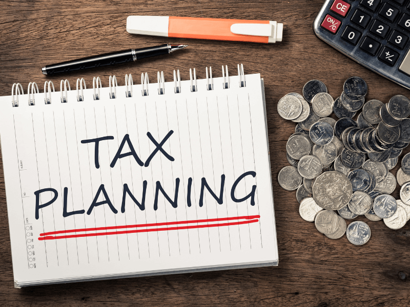 Picture of Tax Planning Binder with coins and calculator on a desk